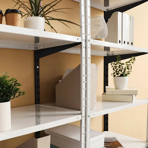 Black Twin Rail Wall Shelving System With Adjustable Twenty Five Inch Shelves And Eleven Point Five Inch Brackets Heavy Duty No Fuss DIY Ready Storage Rack for Kitchen Closet And Home Indoor Includes Rails Brackets And Screws Easy Install with plants and books on white shelves