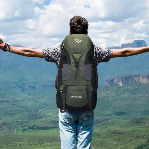 Hiker wearing Ultra Lightweight 50L Hiking Backpack For Men And Women Durable 2.2 Lb Camping Pack in scenic outdoor setting.
