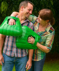 Couple holding Big Leaf Scoops for Fast Leaf Cleanup Ergonomic Handheld Rakes with Oversize Claws in garden setting