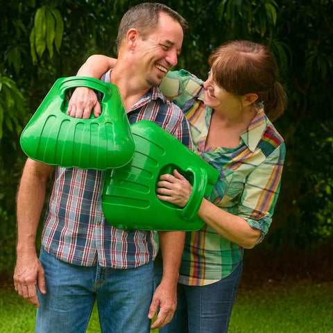 Couple holding Big Leaf Scoops for Fast Leaf Cleanup Ergonomic Handheld Rakes with Oversize Claws in garden setting