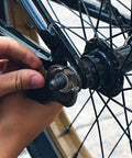 Tightening a bike wheel with Nylon Insert Hex Lock Nuts Set Of 220 Pieces Carbon Steel Black Lock Nuts With Hex Drive For M3 M4 M5 M6 M8 M10 M12 Self Locking Hardware For Vibration Resistance Tough As Nails And Long Lasting Rust Resistant Fasteners