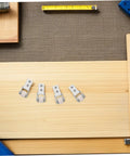 6 Piece White Nylon Sliding Wheels For Furniture Drawers Slick Rolling Track Guide Casters Heavy Duty displayed on wood surface.