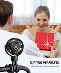 Couple exchanging gift with Portable Stroller Mini Fan visible on a flexible tripod clip, black, with rotatable head