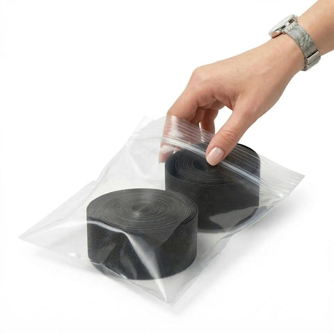 Hand holding Two Pack 26 Inch Rim Strips 65mm Wide 0.6mm Thick Fat Tire Liner Nylon Inner Tube Cushion Protector Anti Puncture For Bikes