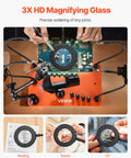 Hands using Magnetic Helping Hands Soldering Station With Four Arms Vise LED Magnifying Lamp Four PCB Holders And 360 Hot Air Gun Holder for electronics repair.