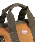 Close-up of Gatemouth 16 Pocket Tool Bag With Wide Zippered Opening 15 Liter Capacity showing heavy-duty webbing handles and logo.