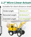 Compact 12V DC Linear Actuator Kit With Controller, 1.2 Inch Stroke, displayed with toy digger for scale