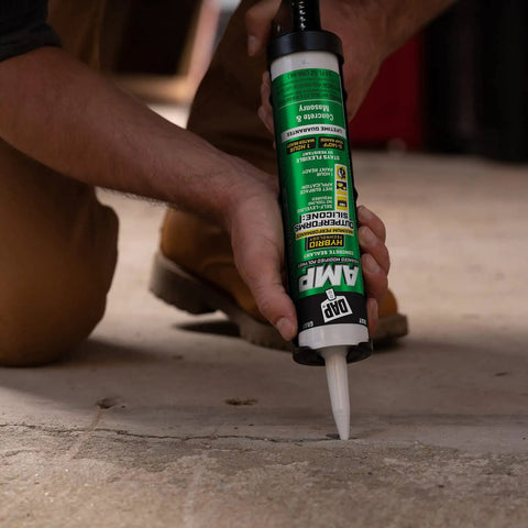 Person applying Gray Concrete Sealant For Driveways, Steps, And Sidewalks, All Weather Tough As Nails Hybrid Polymer Sealant, 9 Oz