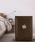 Compact Home Safe Box For Personal Valuables Made From Steel With Shock Proof Construction Perfect For Cash Passport Jewelry And Documents In Cabinets Or Under Bed next to a bed.