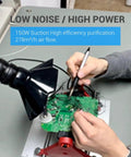 Professional Solder Fume Extractor Delivers 150W Kickass Suction At 258 Cbm Per Hour, hands using extractor near green circuit board.