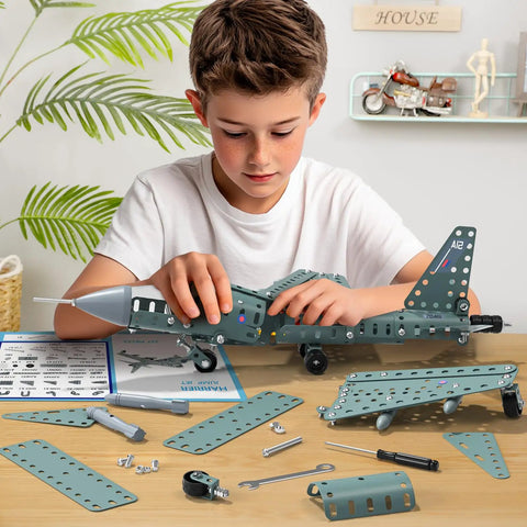 Boy assembling Metal Airplane Model Kit For Kids 8 9 10 11 12 Teens Hands On DIY STEM Building Toys with tools on table