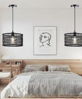 Two Boho Rattan Chandelier Pendant Lights in bedroom, handwoven Burmese rattan, black finish, casting warm 360 degree shadows.