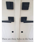 Oil rubbed bronze door handle set with keyed and dummy handles on a white door.