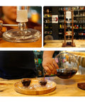 Slick Cold Brew Coffee Tower Featuring A Reliable Ice Drip System For Bold Flavor Kick Holds A Humongous 3000ML Glass Jar settled on a raw brown wood stand.