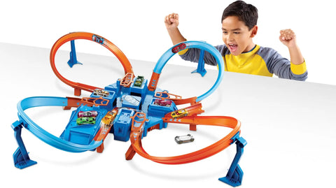 Child playing with Hot Wheels Criss Cross Crash Track Set With 1 To 64 Scale Car Four Intersections Motorized Booster