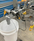 Keep Your Workshop Clean With This Dust Collector Kit For Miter Saw DWS780 No Vacuum Needed Attachment System That Uses A 5 Gallon Bucket Easy Install Mess Free Durable Yellow Sawdust Solution installed on miter saw with bucket