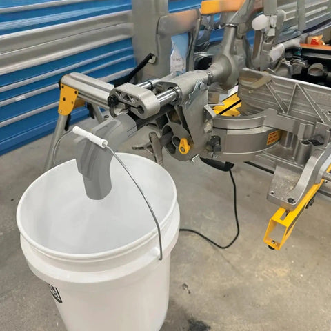 Keep Your Workshop Clean With This Dust Collector Kit For Miter Saw DWS780 No Vacuum Needed Attachment System That Uses A 5 Gallon Bucket Easy Install Mess Free Durable Yellow Sawdust Solution installed on miter saw with bucket
