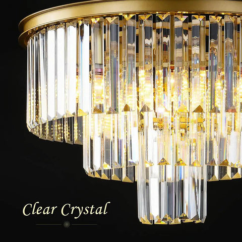 Close-up of a clear crystal detail on a modern chandelier with gold finish, showcasing its luxurious sparkling design.