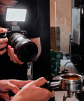 Photographer using Pocket Sized Pro Grade Bicolor Panel Mini LED Light For DSLRs With Adjustable Panel And LCD Display on camera