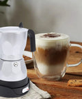 Electric Moka Pot 3 Cup Aluminum Coffee Maker With Detachable Base, Portable Italian Cuban Style Mocha Pot next to coffee cup