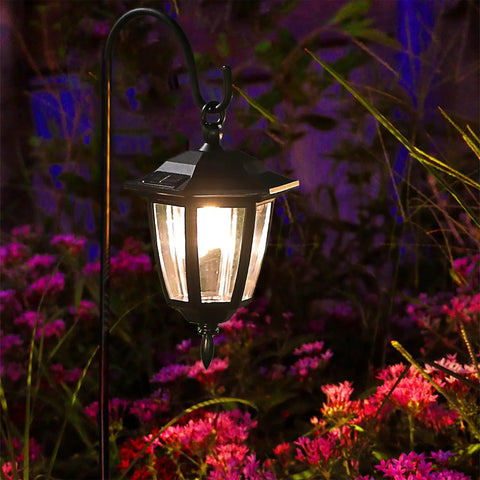 Solar Hanging Lights For Outdoors, 2 Pack With 38 Inch Shepherd Hooks, Waterproof Garden Lanterns glowing among flowers at night