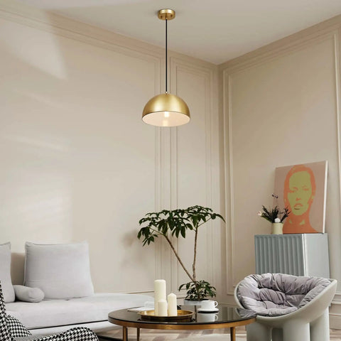 Hazel 1-Light Pendant Light In Matte Brass With Black Fabric Cord hanging in modern living room decor.