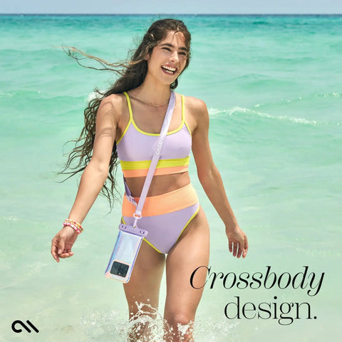Woman at beach with IP68 Waterproof Phone Pouch With Floating Lock Seal In Iridescent Soap Bubble Finish, worn crossbody