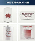Collage of four items: OMTech copper-red laser marking spray, maple leaf tag, normally closed tag, and engraved heart flask.