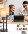 Three Light Table Lamp Set With USB Ports And 2 Prong AC Outlet next to people using devices at a desk, modern rustic decor