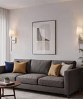 Kira Home Torche 20" Mid Century Modern Wall Sconce for Bathroom Vanity, Pack of 2, installed beside a sofa with decorative pillows.