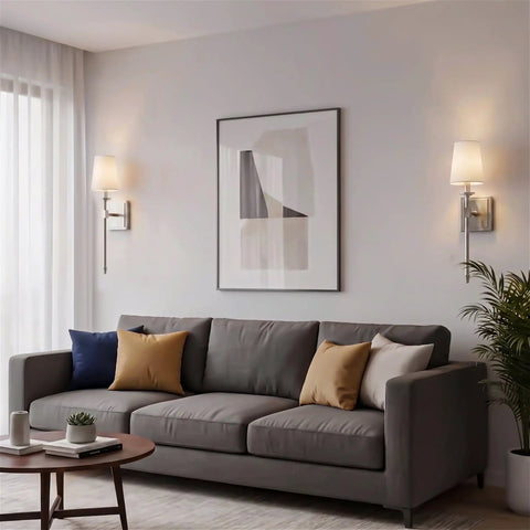 Kira Home Torche 20" Mid Century Modern Wall Sconce for Bathroom Vanity, Pack of 2, installed beside a sofa with decorative pillows.