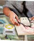 Galpada Solar Powered Jewelry Display Stand With Electric Rotating Turntable For Bracelets And Watches Plus Earrings Store Office Counter Shelf Rack Natural Light Battery Backup Smooth Spin Showcase, showcasing a gold bracelet and a beaded necklace.