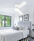 White flush mount low profile 42 inch ceiling fan with light and remote reversible motor in modern bedroom