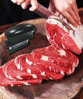 Meat Tenderizer With 48 Stainless Steel Needle Blades Heavy Duty Pro Grade Kitchen Tool next to sliced beef on cutting board