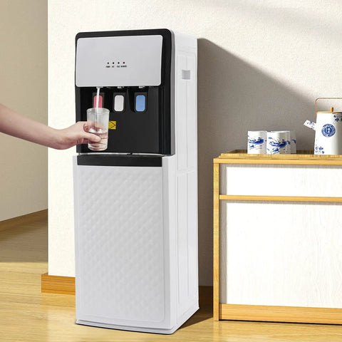 Person dispensing water from Bottom Loading Water Cooler Dispenser With Three Temperature Settings Hot Cold And Room For 5 Gallon Bottles Floor Standing 110V Ideal For Home And Office Use White in kitchen setting.