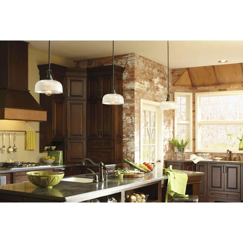 Archie Collection One Light Pendant In Venetian Bronze With Clear Prismatic Glass above modern kitchen island.