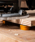 Heavy Duty Three Quarter Inch Aluminum Workbench Dogs Eight Pack With Grippy Pads under a routed board, showing grip in action.