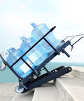 Heavy Duty Electric Stair Climbing Dolly Cart With 550 Lb Load Capacity And Powerful 500W Motor For Easy Moving Jobs Made Simple With Fast Charging Battery loaded with three water bottles on stairs.