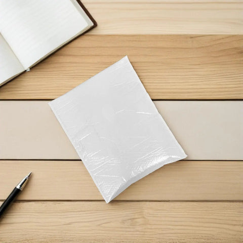 Waterproof Bubble Mailers 10 Pack Self Seal Padded Envelopes 40x50 CM on table, shown with pen and notebook for scale