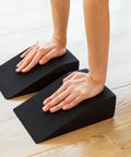 High Grade Foam Yoga Wedge Blocks Set Of Two With Carry Bag Multi Angle Incline support during a deep stretch on wooden floor.