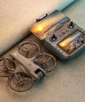 4K HD Dual Camera Drone With Remote Control Screen, brushless power, propeller guards, on surface, showing sunset image