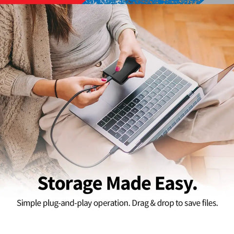 Person using 2TB Portable External Hard Drive USB 3 0 Plug and Play with Matte Black Finish for Quick Backups on laptop