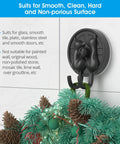 Double Cat Suction Cup Hooks 4 Pack Heavy Duty Wall Holders With Rock Solid Vacuum Grip For Bathroom Shower Towels Coats Waterproof Matte Silver mounted on tile, holding festive greenery.