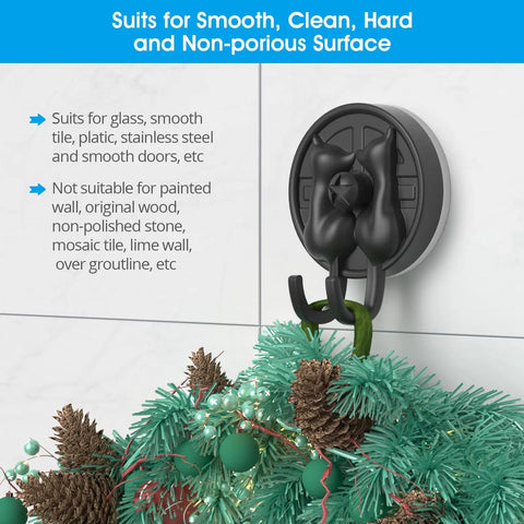 Double Cat Suction Cup Hooks 4 Pack Heavy Duty Wall Holders With Rock Solid Vacuum Grip For Bathroom Shower Towels Coats Waterproof Matte Silver mounted on tile, holding festive greenery.