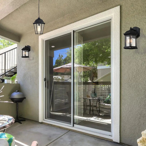 Outdoor Pendant Lights For Porch Black Hanging Lanterns With Adjustable Chain Create A Lit Weatherproof Aluminum Fixture Clear Glass Shade Rust Resistant Exterior Ceiling Light For Front Door Entryway in patio setting.