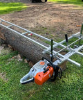 Rail Mill Guide System 9 Ft With 3 Crossbar Kits For Chainsaw Mill setup on a large log in a grassy area