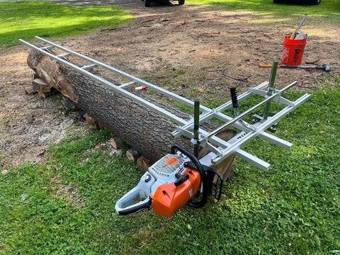 Rail Mill Guide System 9 Ft With 3 Crossbar Kits For Chainsaw Mill setup on a large log in a grassy area