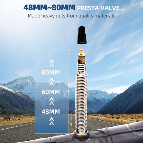 Close-up of 80mm brass Presta valve on Six Pack Replacement Road Bike Inner Tubes, 28 Inch 700x20-25C, with mountains in background