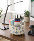 360 Degree Swivel Desk Organizer With Floral Compartments And DIY Stickers filled with pens and accessories on an office desk.