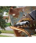Ultra Compact Four Volt Cordless Rotary Tool Featuring Variable Speed and No Sweat Accessory Swaps used for rust removal on metal.